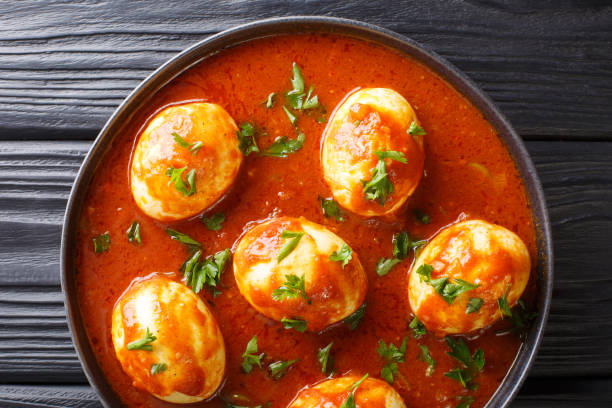 istock Boiled eggs cooked in spicy curry sauce close-up in a plate. Horizontal top view 1185236066