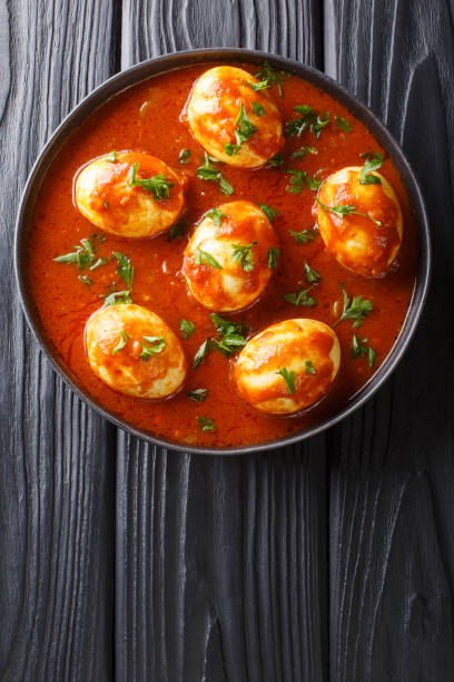 istock Curry egg recipe in spicy sauce close-up in a plate. Vertical top view 1185236126