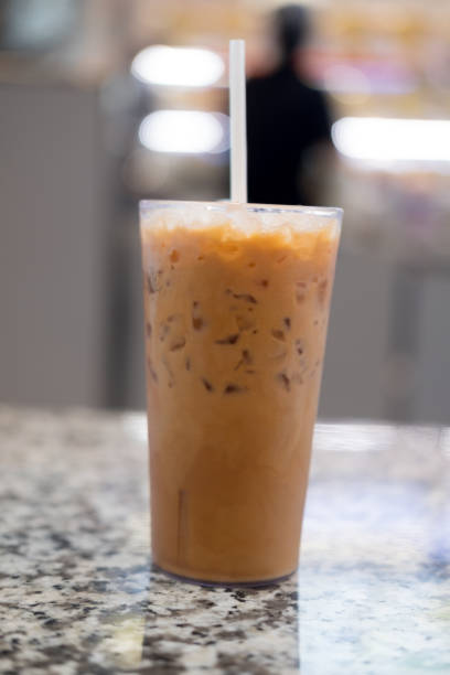 istock Iced milk tea or Thai milk tea in glass with straw 1185237705