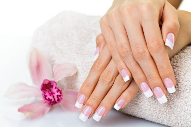 istock Beautiful hands and nails with orchid flower - manicure 1185239199