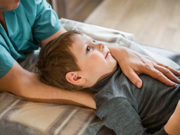 Osteopathy treatment for a child Real osteopath does physiological and emotional therapy for child. Osteopathy Treatment. osteopath photos stock pictures, royalty-free photos & images