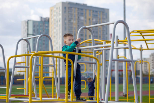 istock A little boy climbs on a metal structure. 1185240695