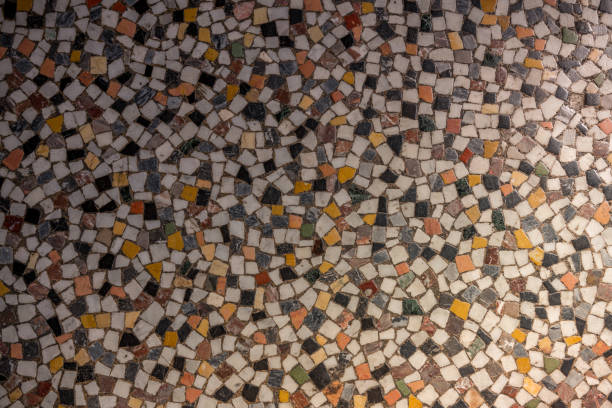 istock Old mosaic floor with different colored natural stones. 1185241169