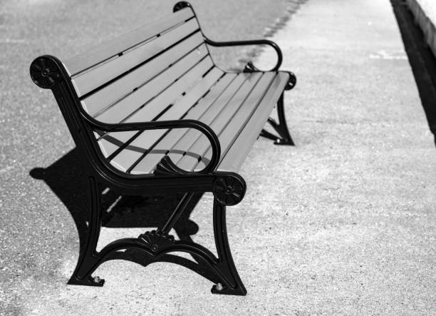 Close up side view of a park bench situation on a beach walkway