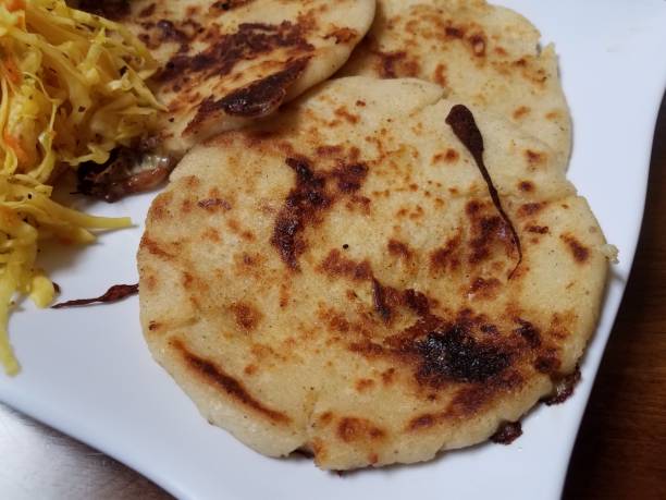 istock pupusa or tortilla stuffed with cheese on plate with cabbage 1185241904