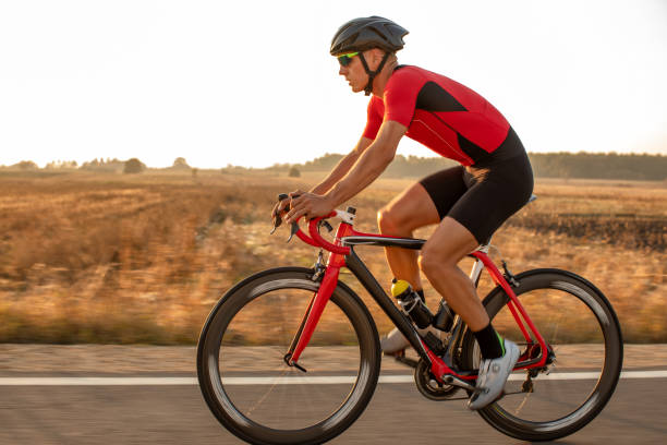 istock Athlete man riding bicycle on the road 1185242033