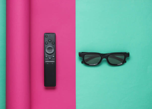 istock Tv remote controller and 3d glasses on wrapped paper background. Pastel color trend, minimalistic still life. Top view 1185242245