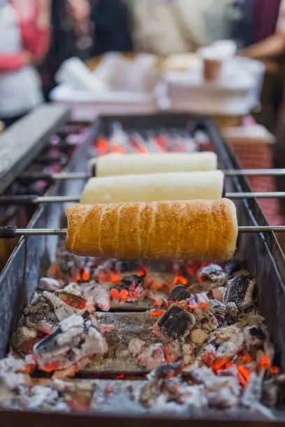 Close up of chimney cake preparing on grill.