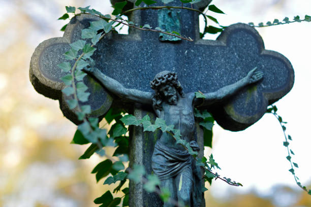 istock Overgrown crucified Jesus Gravestone 1185243927