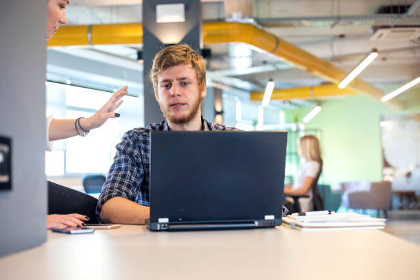 istock Young coworkers in modern office 1185244588