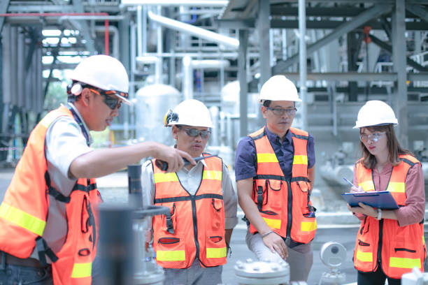 a manager accompanied with his secretary and site engineer  inspect and discuss the plant condition as team work - boiler power station fuel and power generation gas boiler imagens e fotografias de stock