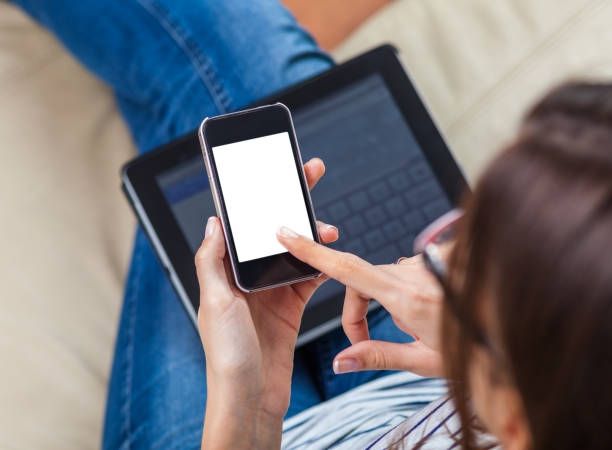 istock Woman using smartphone and digital tablet at home 1185246430