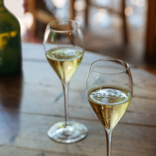 Prosecco flutes Flutes filled with sparkling Prosecco, in a restaurant in Valdobbiadene. Prosecco is a white sparkling wine cultivated and produced in Valdobbiadene-Conegliano area. uncork wine stock pictures, royalty-free photos & images