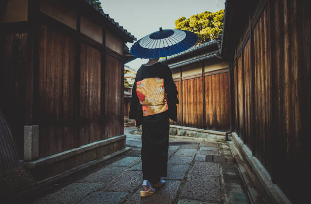 村を歩く美しい日本人先輩女性。典型的な日本の伝統的なライフスタイル - 舞妓 ストックフォトと画像