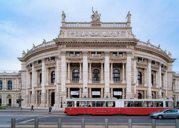 Street view public tram near Burgtheater in Hofburg Vienna Vienna, Austria - May 19, 2019: Street view with public tram near Burgtheater in Hofburg Complex in Old city center. Innere Stadt in Wien. Cityscape. Theater building landmark. Theatre architecture. burgtheater vienna stock pictures, royalty-free photos & images
