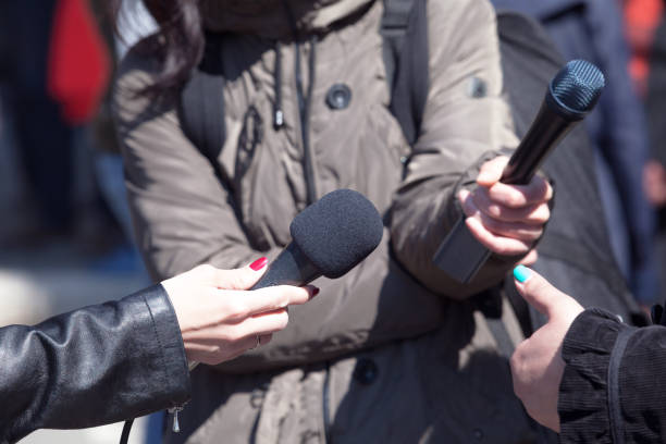 istock Journalists holding microphones at news conference 1185247113