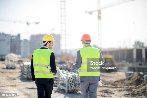 Architect And Engineer On Construction Site Check Documents And ...