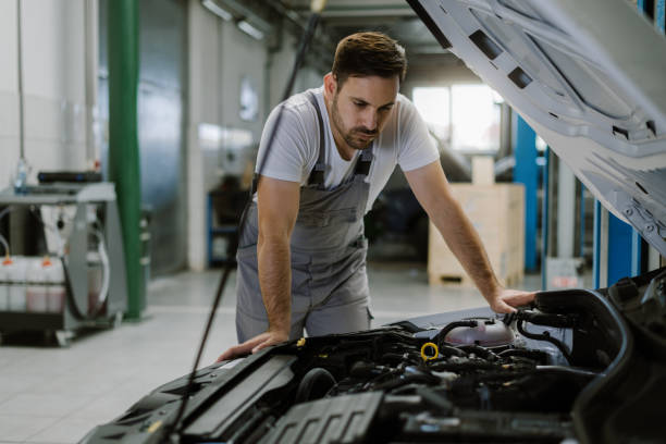 istock Auto mechanic analyzing problems on a car engine in a repair shop 1185249901