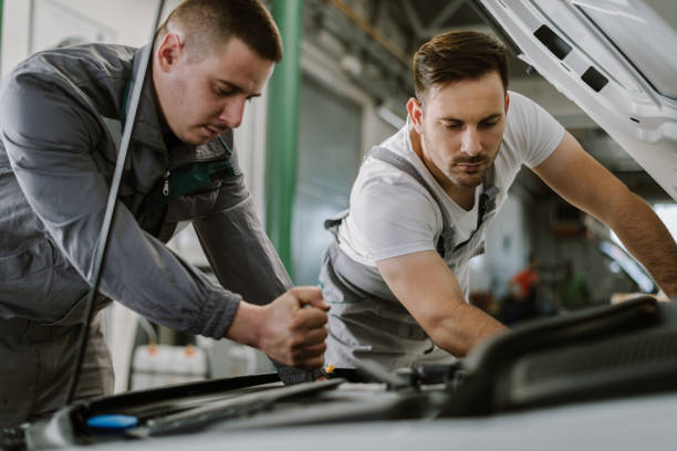 istock Auto mechanics working on car in a workshop 1185250637