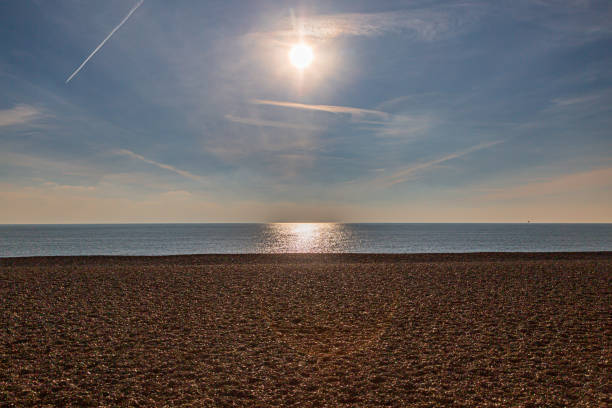 Looking out to sea over the pebble beach at Brighton, on a sunny winters day
