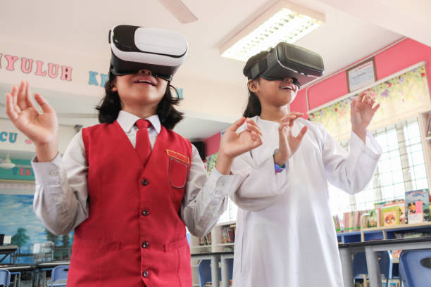 istock Two Schoolgirls Using VR Goggles in School 1185251338