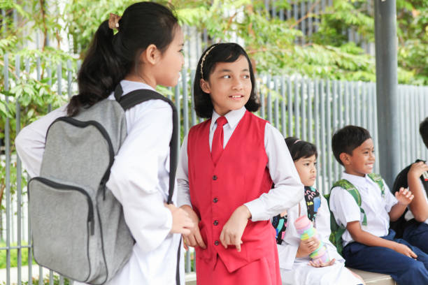 istock School Children Waiting For Bus in Malaysia 1185251344