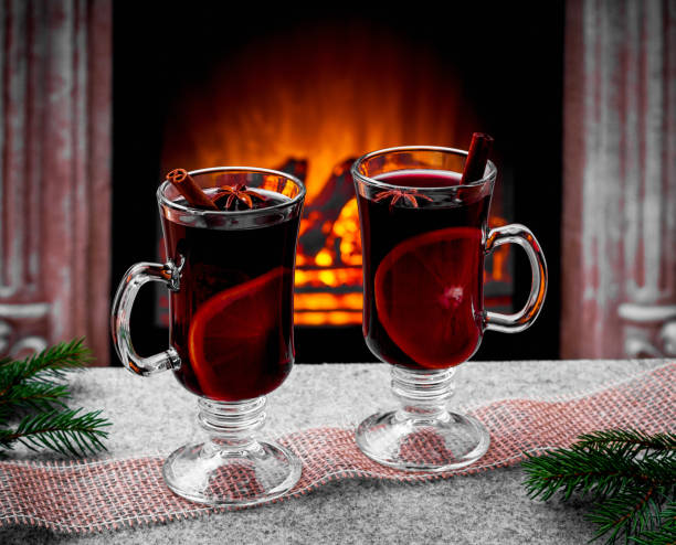 istock Two mulled wine glasses by the fireplace 1185255563