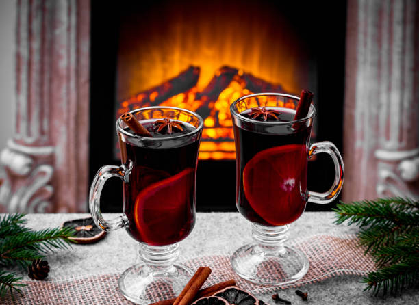 istock Two mulled wine glasses by the fireplace 1185255622