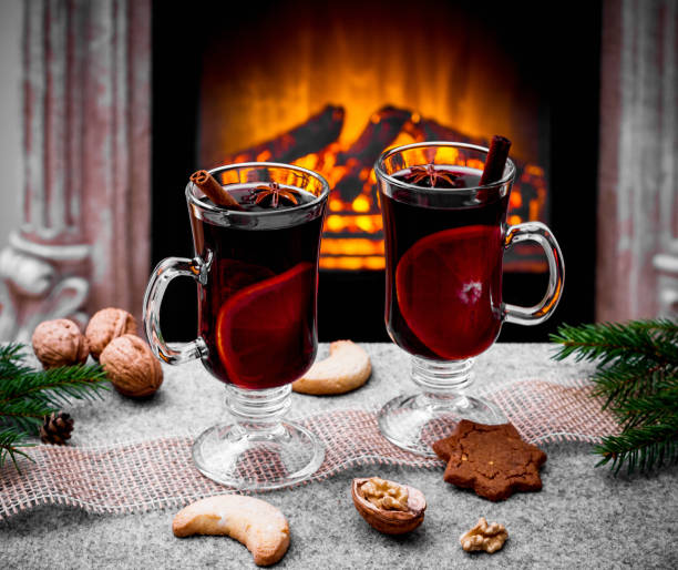 istock Two mulled wine glasses by the fireplace 1185255634