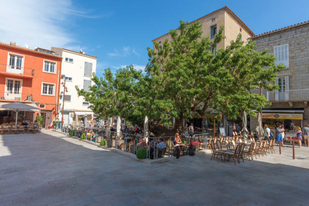 Shaded tables on the busy main square, Porto Vecchio, Corsica stock photo