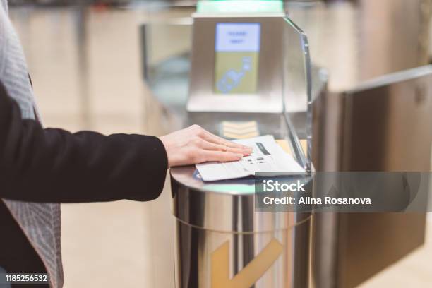 Electronic Boarding Pass And Passport Control In The Airport Hand With Boarding Pass At The Turnstile Stock Photo - Download Image Now