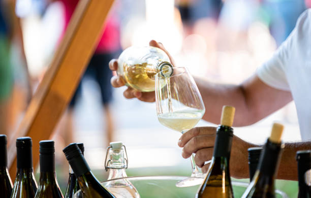 Pouring a glass of white wine during a wine tasting