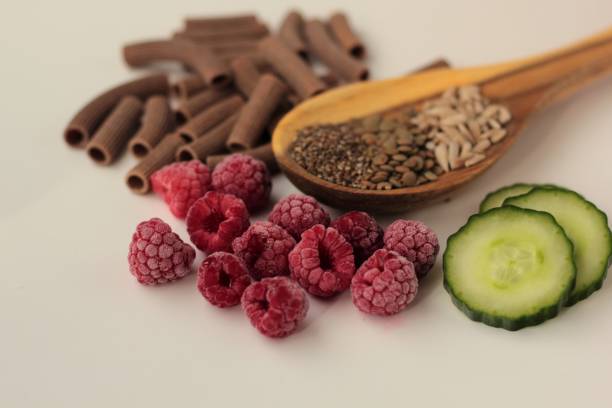 PCOS diet Sample foods from low-GI PCOS (Polycystic Ovary Syndrome) diet. Lentils, chia seeds, sunflower seeds, buckwheat pasta, raspberries and cucumber. polycystic ovary syndrome photos stock pictures, royalty-free photos & images
