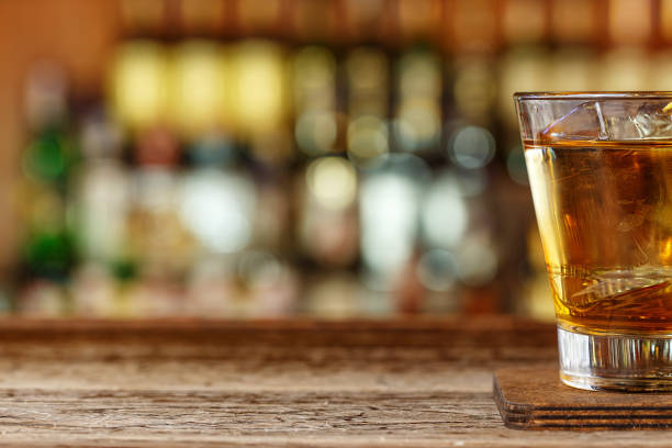 istock Cocktail rusty nail with whiskey place for text, drink on bar rack on blurred background 1185258472