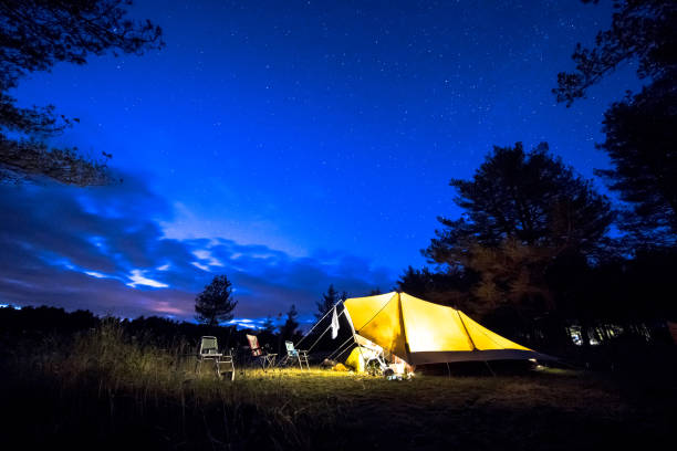 istock Family tent on camping ground under stars 1185258607