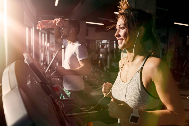 istock Fit woman on treadmill in gym running 1185258656
