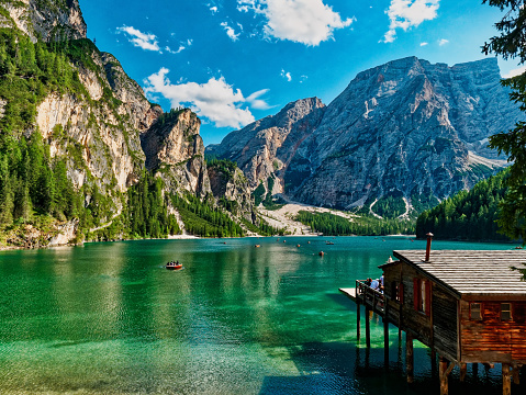 Amazing Panoramic view of Braies Lake with hut and boats in Dolomites mountains in summer Sudtirol, Italy