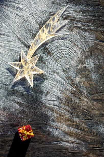 istock Christmas star on wooden   background  with  snow 1185260193