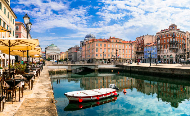 Landmarks and beautiful places (cities) of northern Italy - elegant Trieste with charming streets and canals Downtown of Trieste with canals and restaurants, neo classical photos stock pictures, royalty-free photos & images