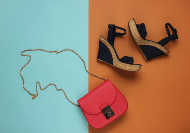 istock Minimalistic feshin still life. Sandals with platform, red leather bag on colored background. Top view 1185260798