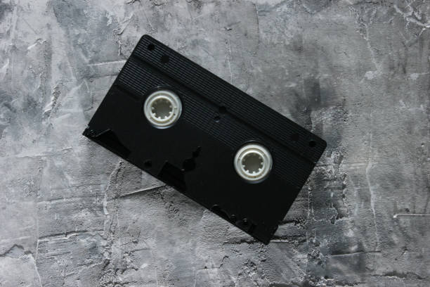 istock Viideo cassette on a gray concrete background. Top view 1185263145