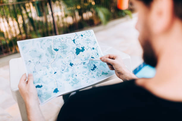 Young man looking at map planning the travel vacation