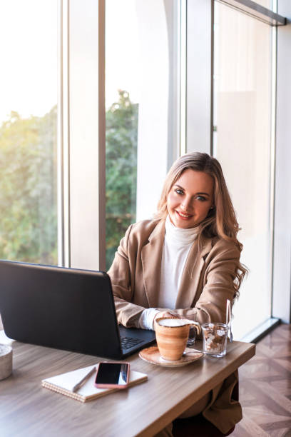 istock Beautiful business woman sitting in cafe and taking notes in notebook. 1185263959