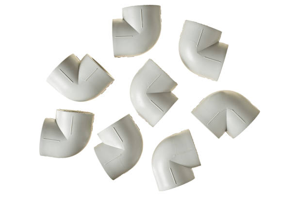 istock Scattered polypropylene, plastic corners of 90 degree for connecting pipe for water or other liquid for heating room isolated on white background without shadow. Top view 1185265061