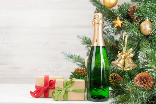 istock Christmas card with decorated fir tree and champagne 1185265397