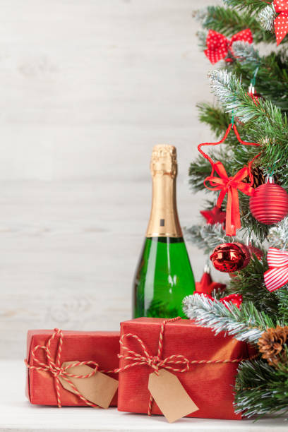 istock Christmas card with decorated fir tree and champagne 1185265461