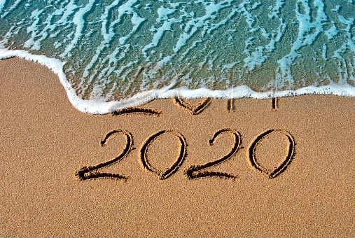 New year 2020 written on the beach
