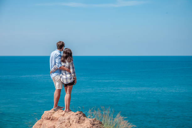 istock Young couple look at sea 1185266326
