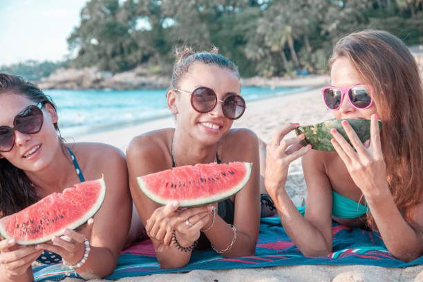 istock Female friends eating watermelon 1185266331