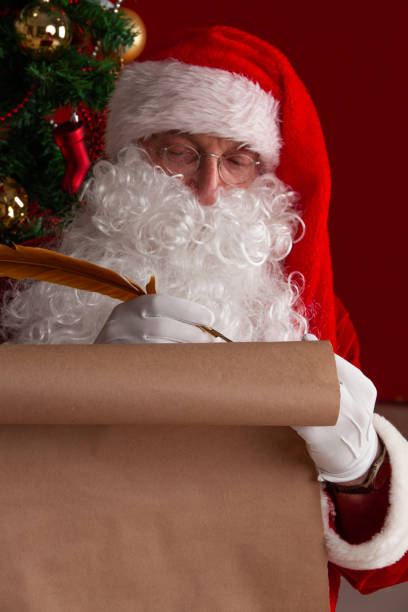 istock Santa Claus writing on old paper 1185266334